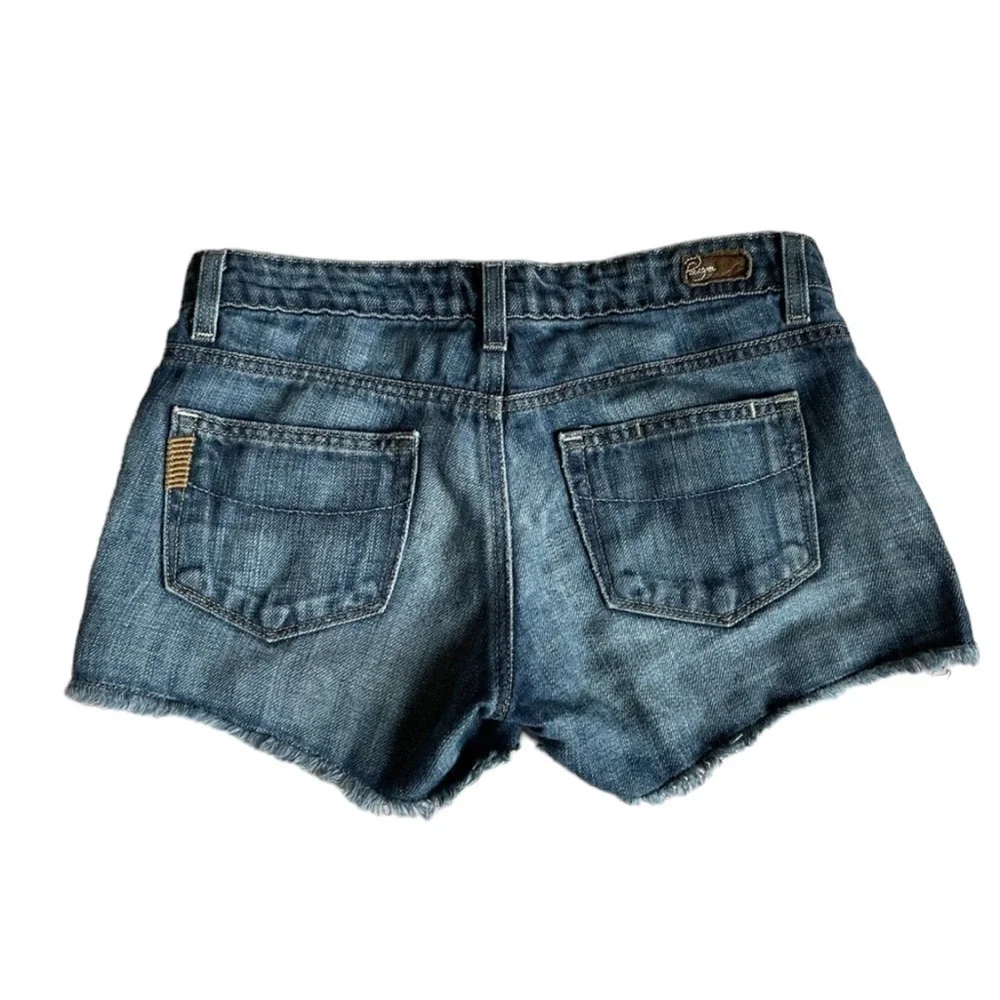 PAIGE Medium Wash Cut Off Raw Hem Jeans Shorts